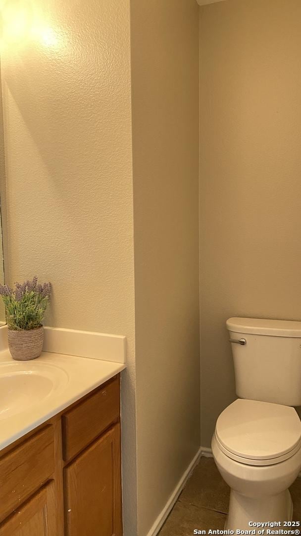 bathroom featuring tile patterned floors, toilet, and vanity