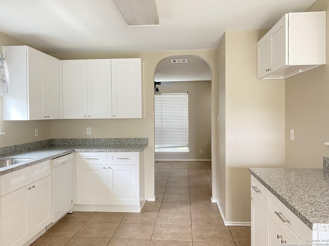 kitchen with light tile patterned floors, white cabinetry, visible vents, baseboards, and white dishwasher