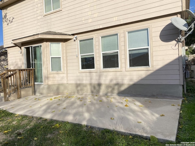 view of property exterior with a patio area