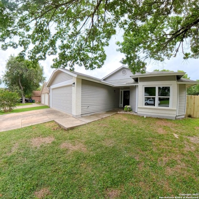 13243 Larkfield, San Antonio, TX 78233 - ranch-style house with concrete driveway, a garage, a front lawn, and fence