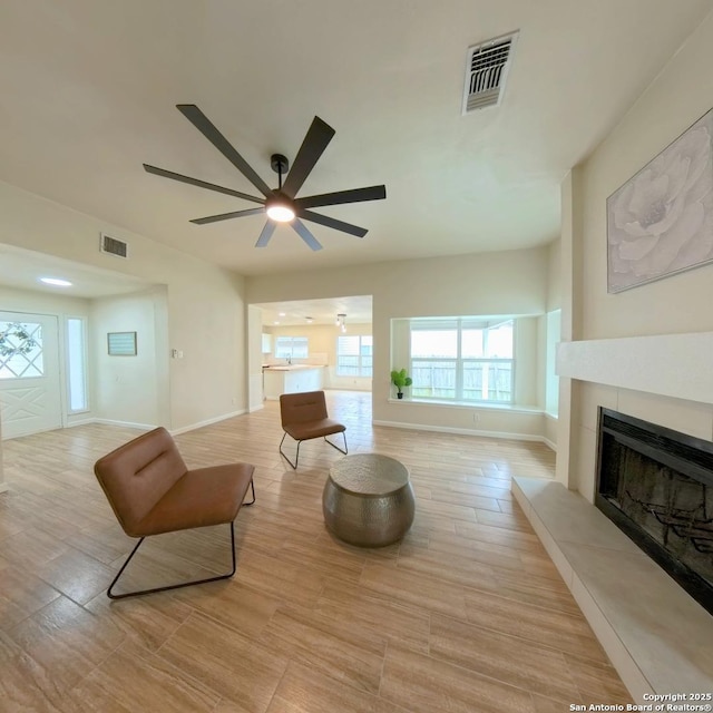 13243 Larkfield, San Antonio, TX 78233 - living room with a fireplace, plenty of natural light, a ceiling fan, and visible vents