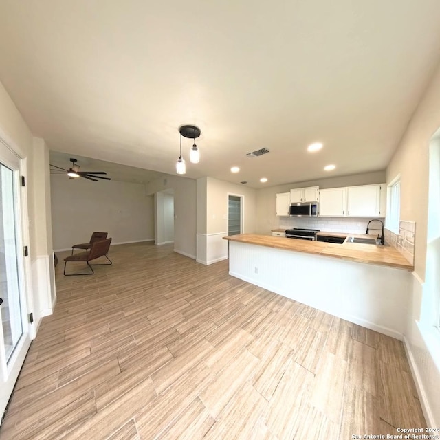 13243 Larkfield, San Antonio, TX 78233 - kitchen with light wood-type flooring, stainless steel appliances, butcher block counters, and visible vents