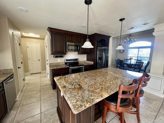 kitchen with stainless steel appliances, visible vents, dark brown cabinetry, light tile patterned floors, and a kitchen island