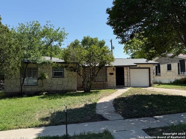 306 Lemur Dr, San Antonio, TX 78213 - ranch-style home with concrete driveway, a garage, stone siding, and a front yard