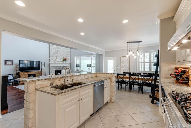 kitchen featuring dishwasher, ornamental molding, a sink, open floor plan, and extractor fan