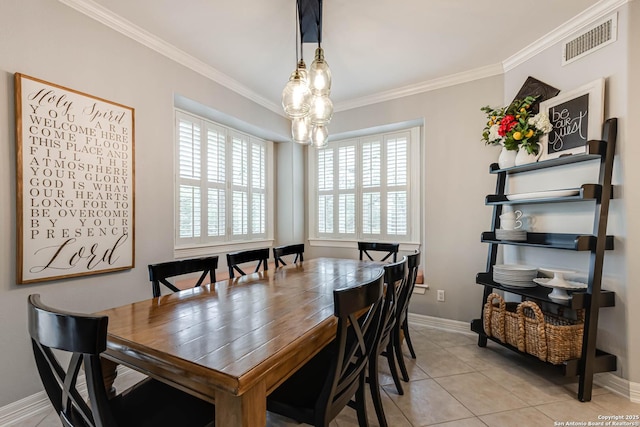 dining space with crown molding, baseboards, light tile patterned floors, and visible vents