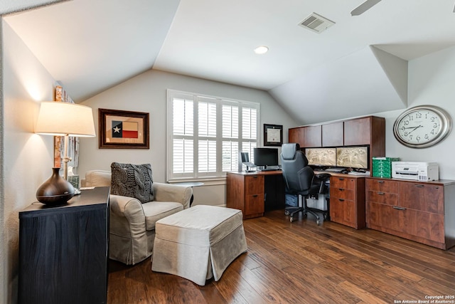 home office featuring a ceiling fan, lofted ceiling, dark wood-type flooring, and visible vents