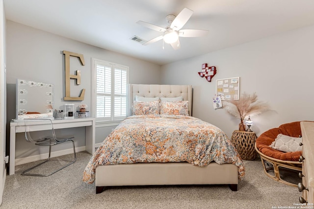 carpeted bedroom with visible vents, baseboards, and a ceiling fan