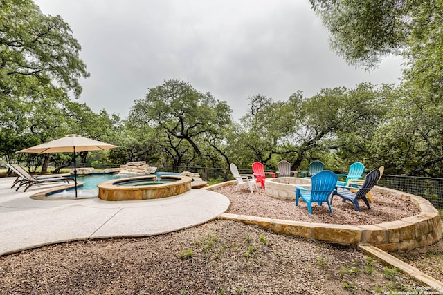 view of play area featuring an outdoor fire pit, a patio area, an in ground hot tub, and a fenced in pool