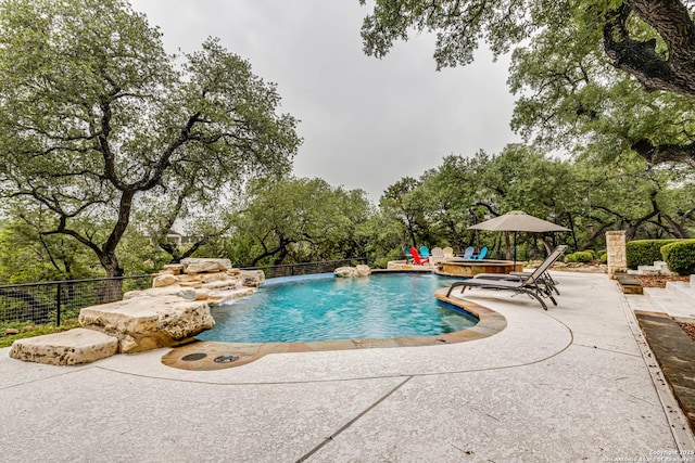 view of swimming pool with a patio and a fenced in pool