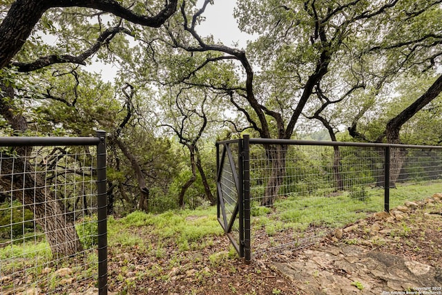 view of gate featuring fence