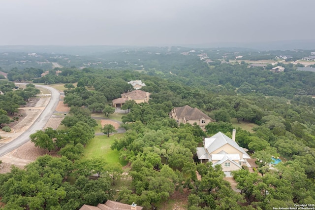 birds eye view of property with a forest view