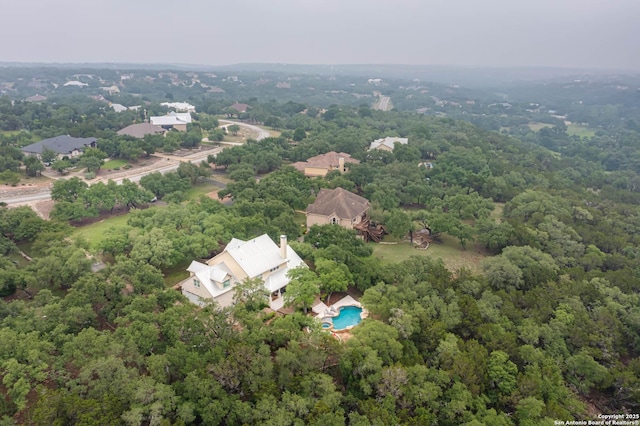 birds eye view of property with a wooded view