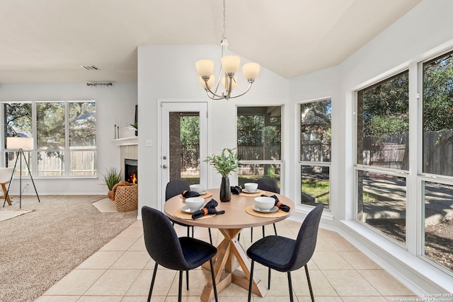 20437 Wild Spgs, San Antonio, TX 78258 - dining space with light tile patterned floors, a notable chandelier, visible vents, light colored carpet, and vaulted ceiling
