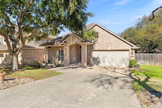 20437 Wild Spgs, San Antonio, TX 78258 - view of front of home featuring brick siding, aphalt driveway, a front lawn, and fence