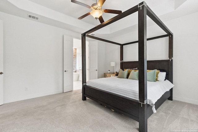 bedroom featuring carpet floors, baseboards, ensuite bath, and ceiling fan