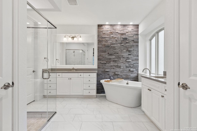 bathroom with a shower stall, a soaking tub, recessed lighting, two vanities, and marble finish floors