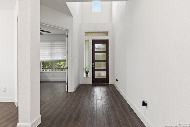 entryway featuring dark wood finished floors and baseboards