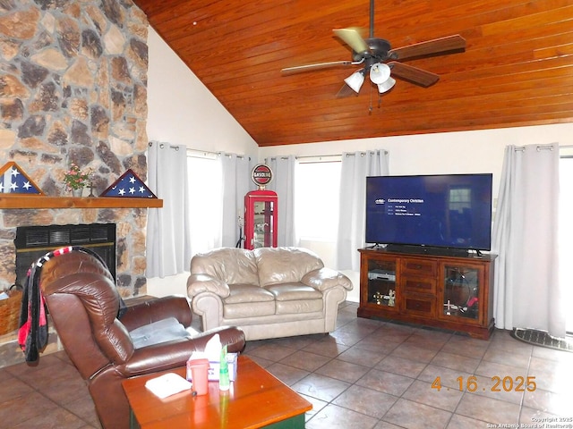 525 Cherry Rdg, Floresville, TX 78114 - living area with wood ceiling, healthy amount of natural light, tile patterned flooring, ceiling fan, and a stone fireplace