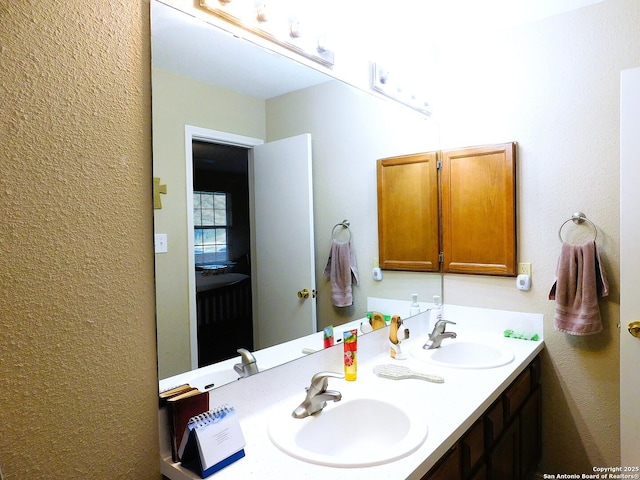 525 Cherry Rdg, Floresville, TX 78114 - bathroom with double vanity and a textured wall