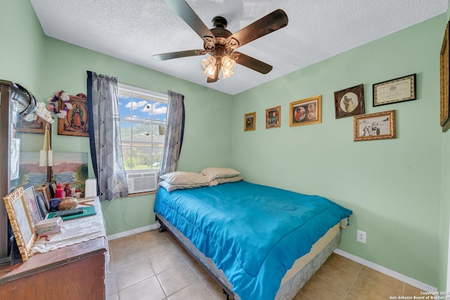 5118 War Cloud, San Antonio, TX 78242 - bedroom with light tile patterned flooring, a textured ceiling, a ceiling fan, and baseboards