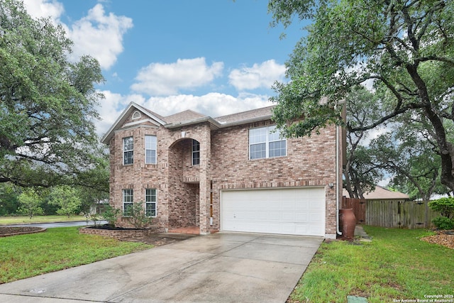 traditional home featuring driveway, an attached garage, and brick siding