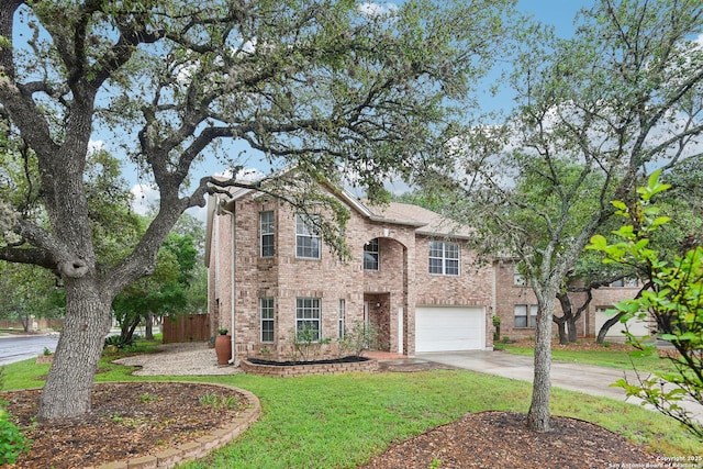 traditional-style home featuring driveway, a garage, and brick siding
