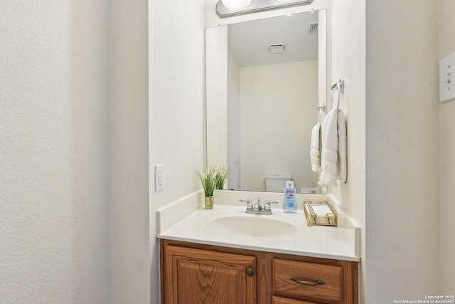 half bathroom with vanity and toilet
