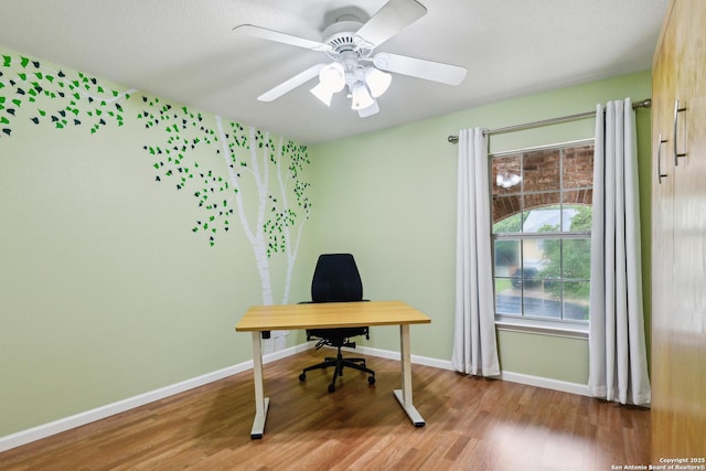 office with light wood-style flooring, baseboards, and a ceiling fan