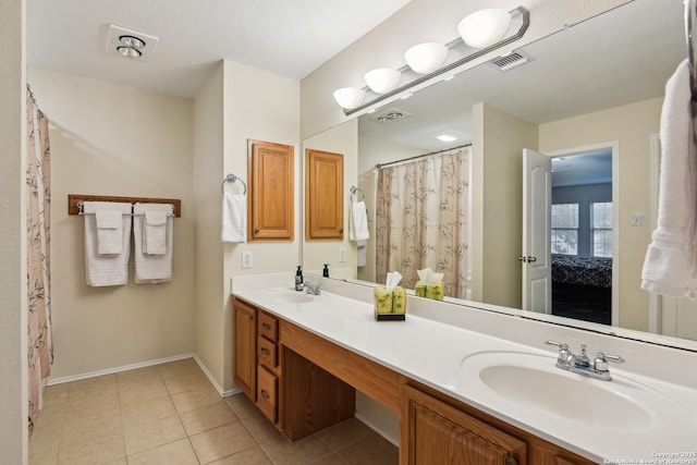 full bath featuring tile patterned flooring, double vanity, baseboards, and curtained shower