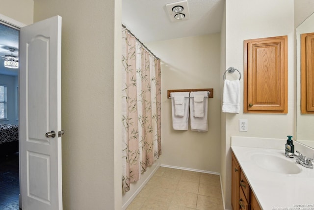 bathroom with vanity, ensuite bath, curtained shower, baseboards, and tile patterned floors