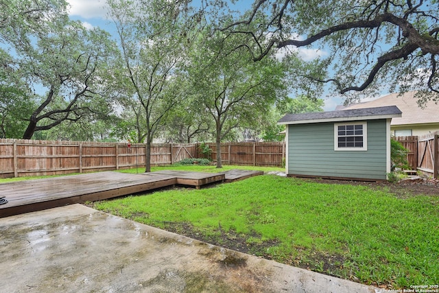 view of yard with a wooden deck and an outdoor structure