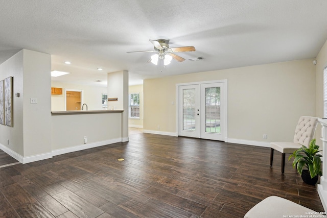 unfurnished living room featuring ceiling fan, wood finished floors, baseboards, recessed lighting, and a textured ceiling