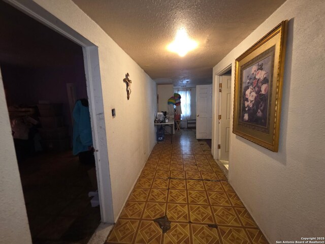 238 Lone Star, San Antonio, TX 78204 - hallway with a textured ceiling, tile patterned flooring, and a textured wall