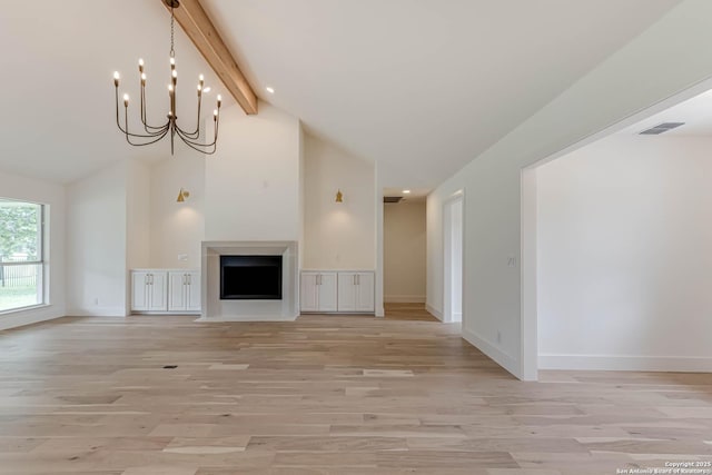 7335 Scintilla Ln, Boerne, TX 78015 - unfurnished living room featuring light wood-style flooring, beamed ceiling, baseboards, a fireplace, and a chandelier