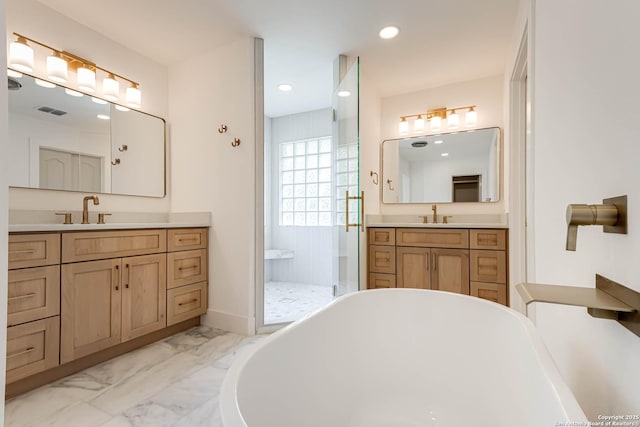 7335 Scintilla Ln, Boerne, TX 78015 - full bathroom featuring marble finish floors, a freestanding tub, a walk in shower, two vanities, and recessed lighting