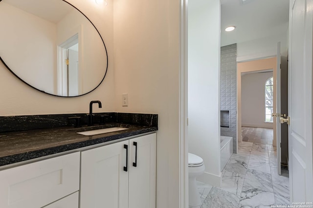 7335 Scintilla Ln, Boerne, TX 78015 - full bathroom featuring marble finish flooring, toilet, vanity, a tub to relax in, and recessed lighting