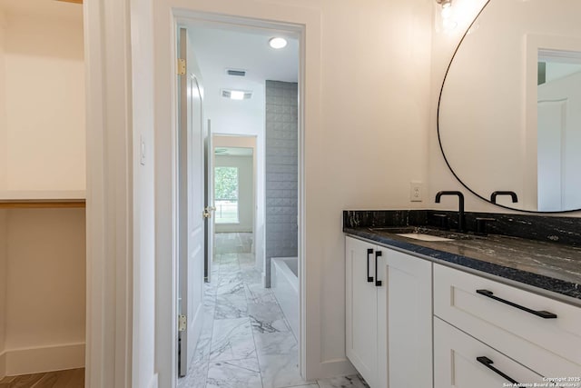 7335 Scintilla Ln, Boerne, TX 78015 - bathroom featuring marble finish floors, vanity, baseboards, and washtub / shower combination
