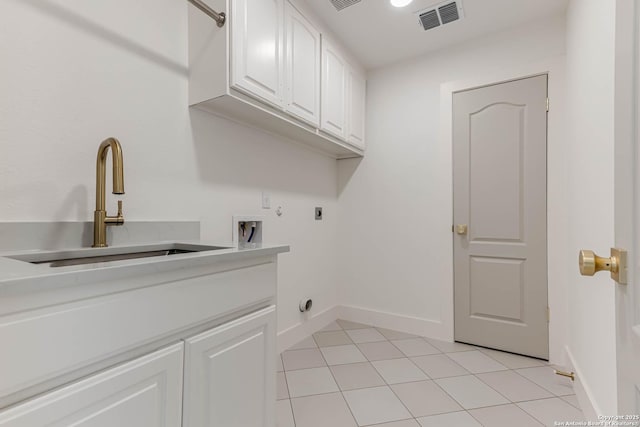 7335 Scintilla Ln, Boerne, TX 78015 - washroom with cabinet space, electric dryer hookup, washer hookup, baseboards, and light tile patterned floors