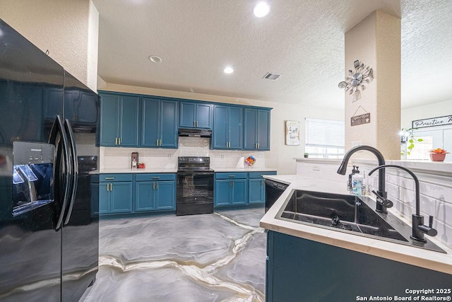 kitchen featuring black appliances, blue cabinetry, under cabinet range hood, light countertops, and recessed lighting