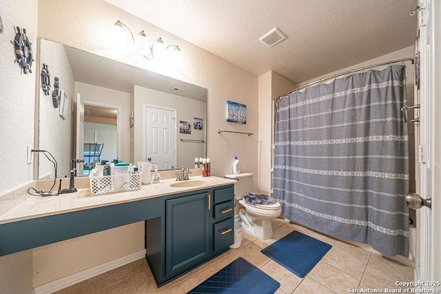 bathroom featuring a textured wall, a textured ceiling, toilet, vanity, and tile patterned floors