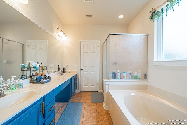 full bath with a stall shower, a garden tub, double vanity, and tile patterned flooring
