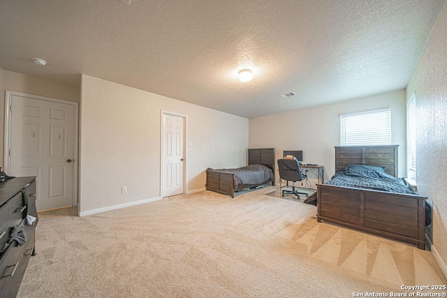 bedroom featuring carpet, a textured ceiling, and baseboards