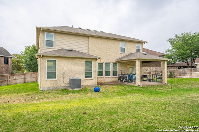 rear view of house with a patio and central AC