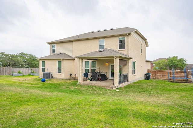 rear view of house with a patio, central air condition unit, and a trampoline