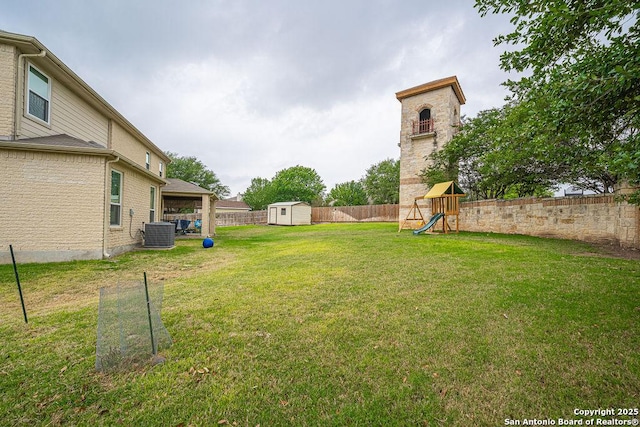 view of yard with a playground, central AC unit, a storage shed, and an outdoor structure