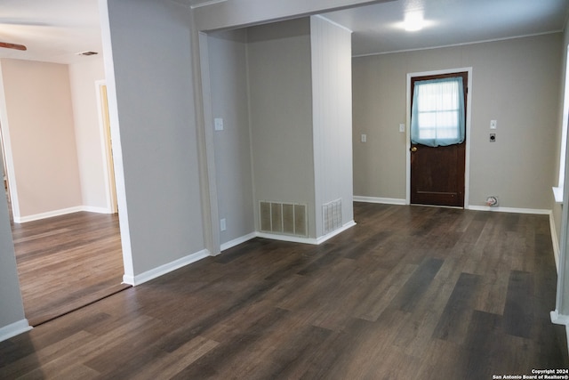 foyer entrance with dark wood-type flooring, baseboards, ceiling fan, and ornamental molding
