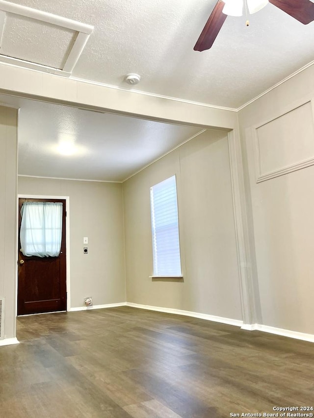 foyer entrance with wood finished floors, a ceiling fan, and baseboards