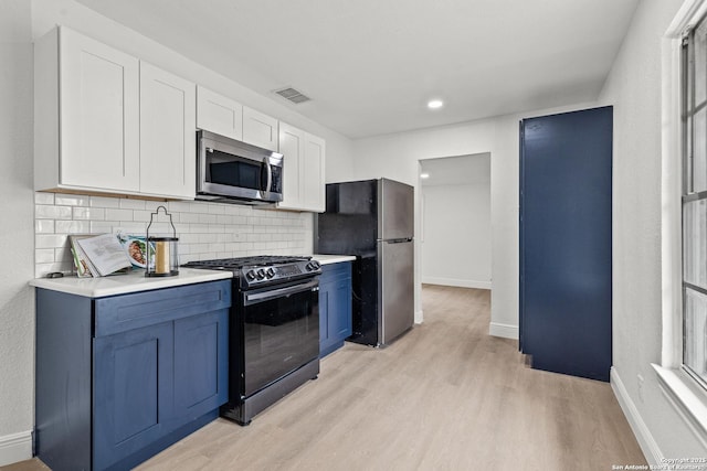3327 K, San Antonio, TX 78220 - kitchen with appliances with stainless steel finishes, light wood-type flooring, decorative backsplash, light countertops, and white cabinetry