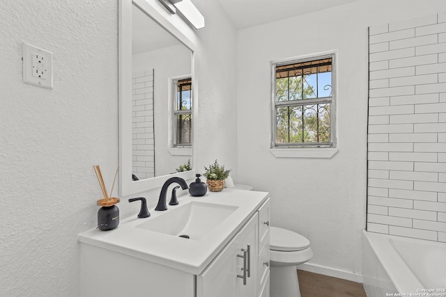 3327 K, San Antonio, TX 78220 - full bath with toilet, vanity, a textured wall, wood finished floors, and baseboards